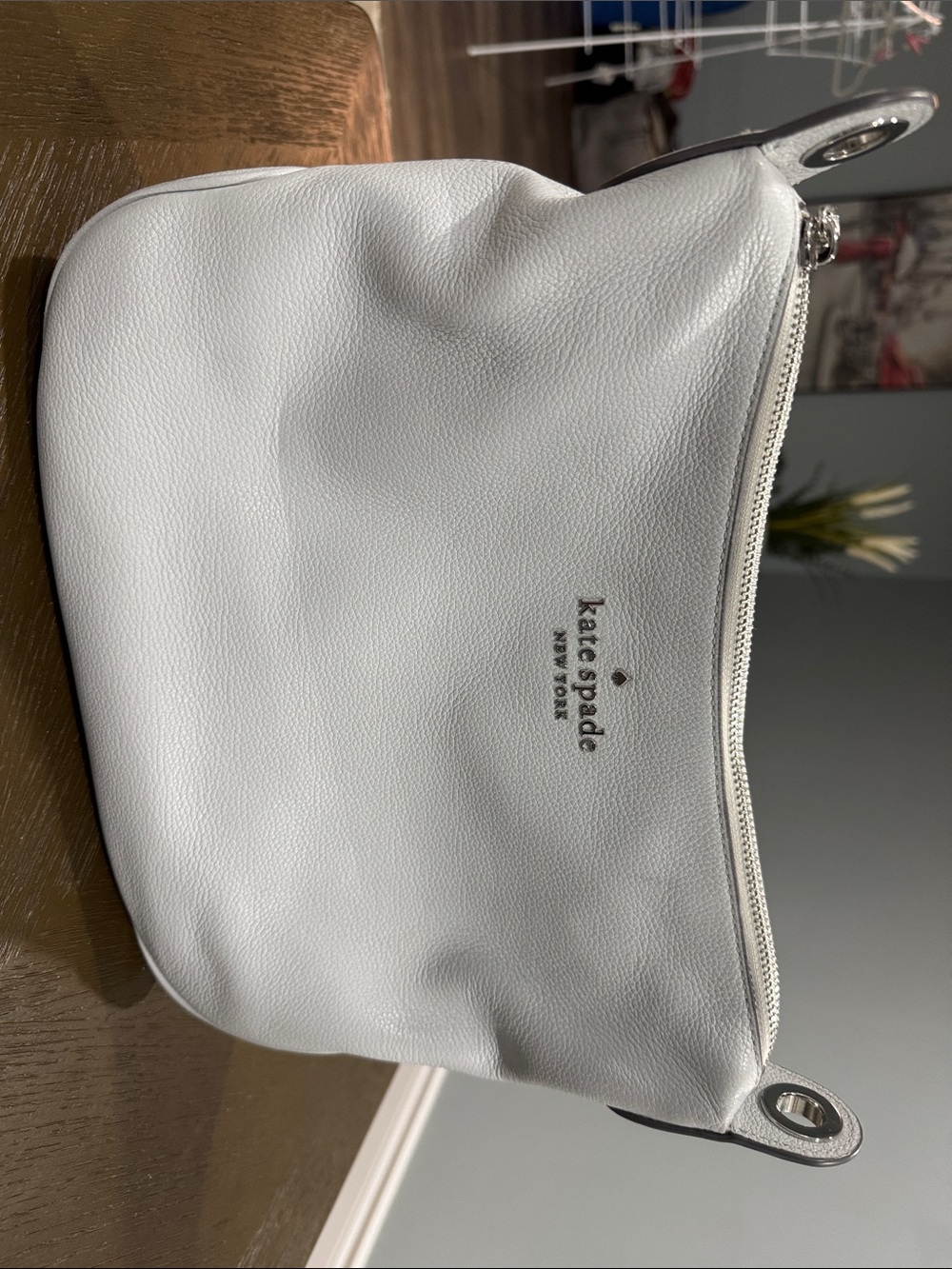 kate spade white pebbled leather zip pouch with silver logo